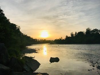 Scenic view of lake against sky during sunset