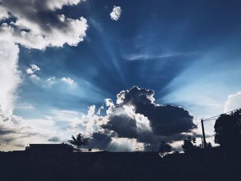 Low angle view of silhouette building against sky