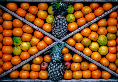 Full frame shot of orange and pineapple fruits arranged