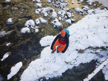 High angle view of person skiing on rock