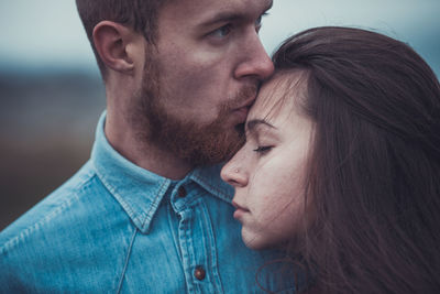 Close-up of couple embracing outdoors