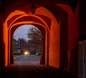 Illuminated corridor of building at night