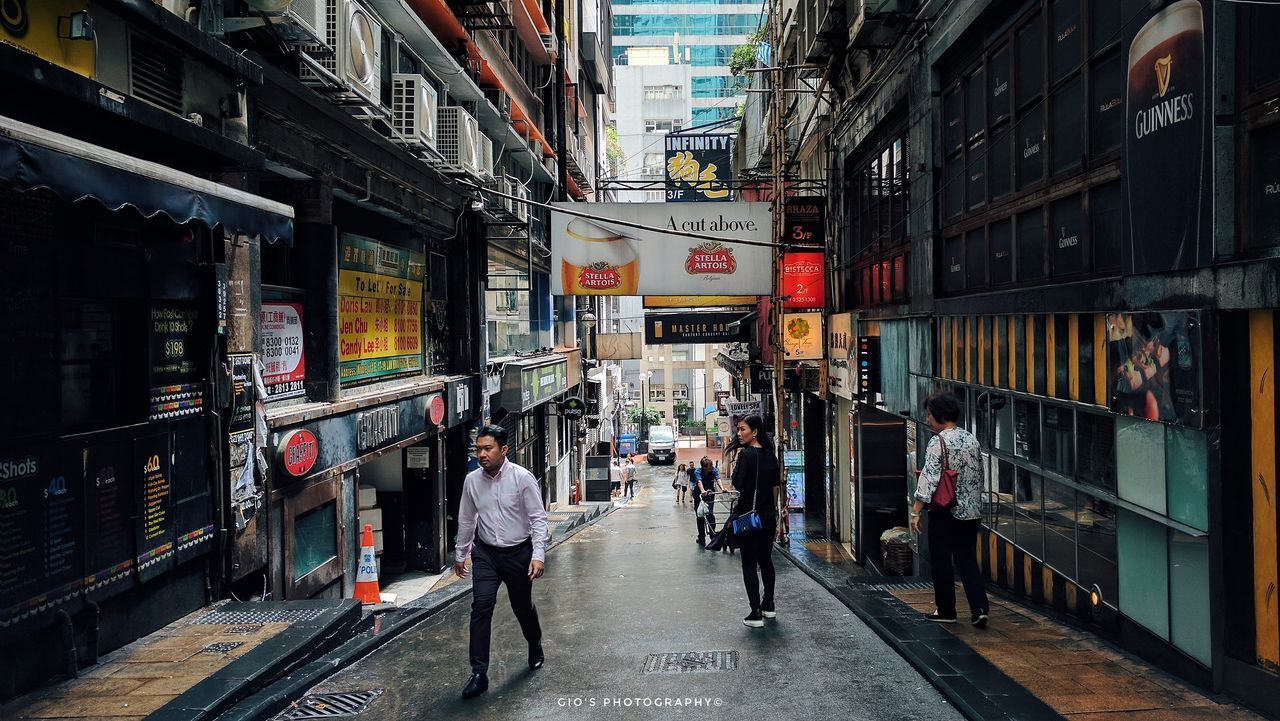 PEOPLE ON STREET AMIDST CITY IN STORE