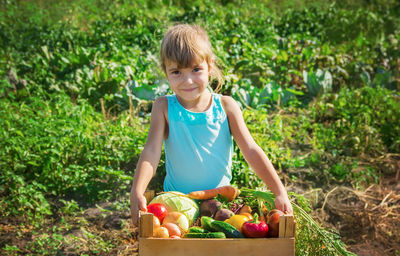 Portrait of cute girl picking apples in basket