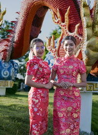 Happy chinese new year. asian woman wearing traditional cheongsam qipao dress.