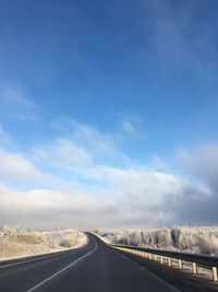 Empty road along countryside landscape