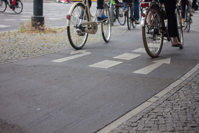 Low section of man riding bicycle on road