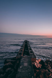 Scenic view of sea against clear sky during sunset