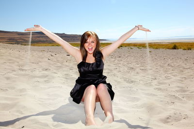 Full length of woman standing on beach