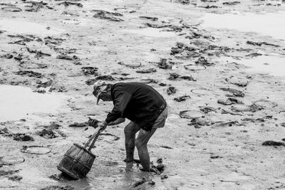 Rear view of man working at beach