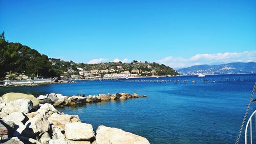 Scenic view of bay against blue sky