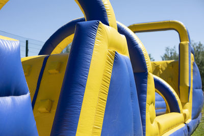 Close-up of yellow pipe against blue sky