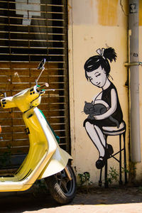 Close-up of motor scooter on wall