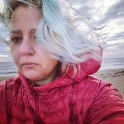 Portrait of woman with pink hair at beach