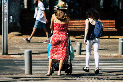 Rear view of women walking on street