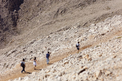 High angle view of friends hiking on mountain