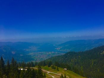 Scenic view of landscape against blue sky