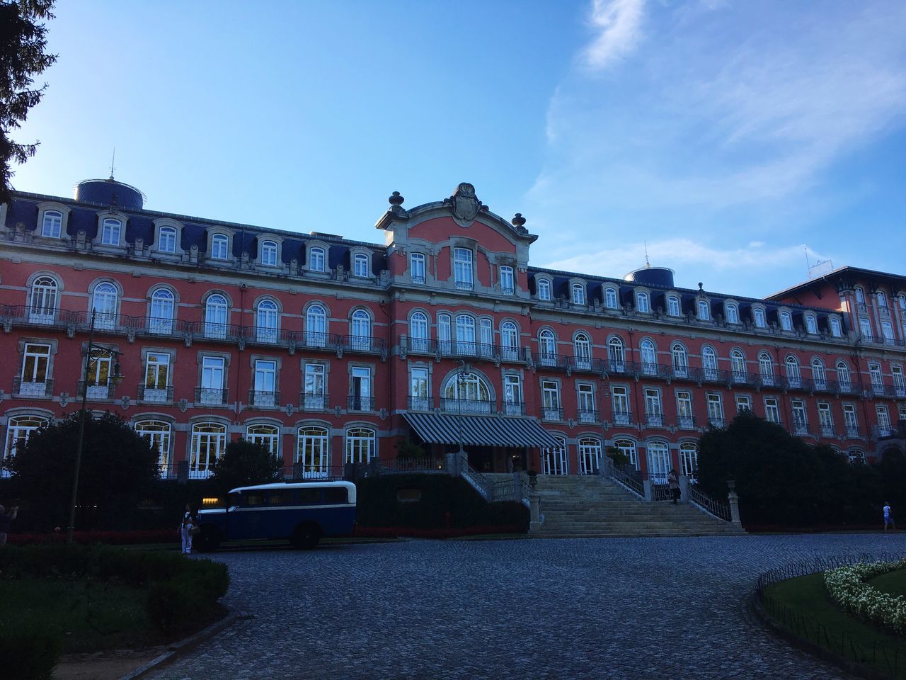 architecture, building exterior, built structure, car, transportation, sky, land vehicle, street, in front of, city, facade, day, history, outdoors, cloud - sky, footpath