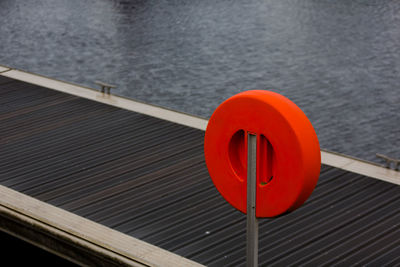 Buoy life belt on pier over lake