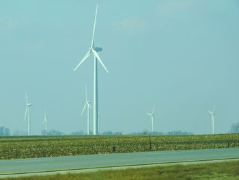 Windmill on field against sky