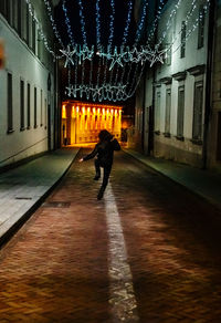 Rear view of man walking on street