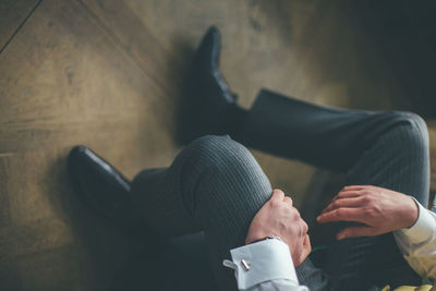 Low section of man sitting on sofa