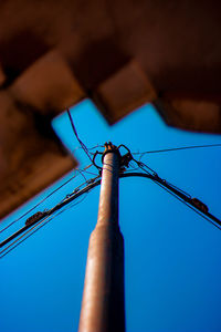 Low angle view of pole against blue sky