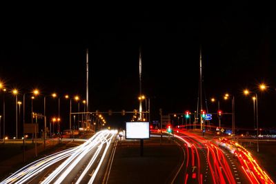 Light trail on street against sky