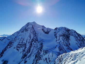 Scenic view of snowcapped mountains against clear sky