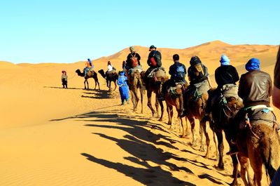 Tourists walking on desert