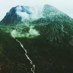 Scenic view of waterfall against sky