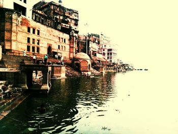 Boats in canal with buildings in background