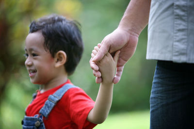 Father and boy looking away outdoors