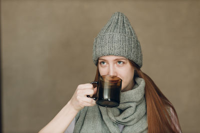 Portrait of young woman drinking water