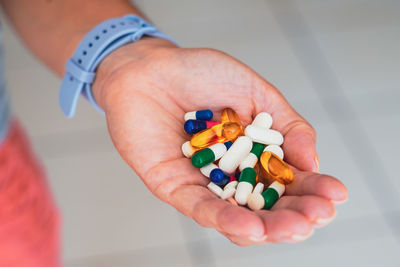 Cropped hand of man holding pills