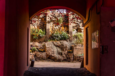 An arch to the yard with ancient stones decorated with flowers in vyborg