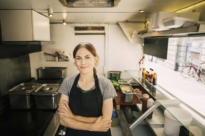 Portrait of confident female chef in food truck