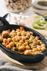 Close up still life of chickpea stew with vegetables, herbs and beef