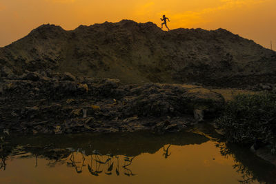 Scenic view of rocks against sky during sunset