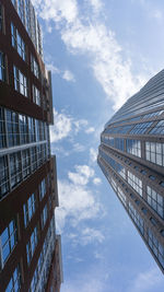 Low angle view of modern building against cloudy sky