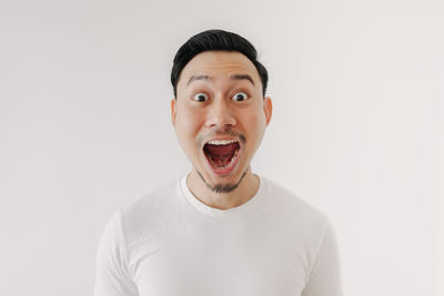 Portrait of young man against white background