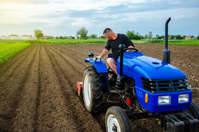 A farmer is cultivating a farm field. preparatory earthworks before planting a new crop. land