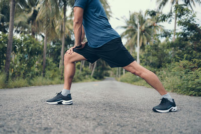 Low section of man running on plant