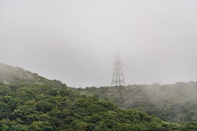 Low angle view of electricity pylon against sky