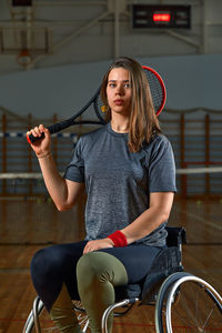 Portrait of young woman sitting on wheelchair