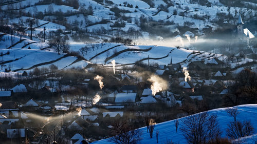 Snow covered landscape against mountains