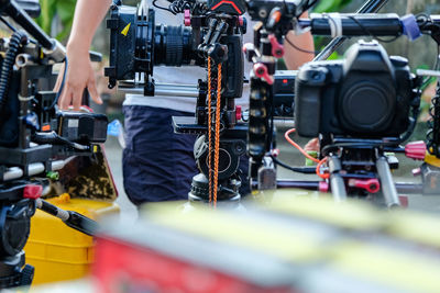 Midsection of man standing by camera