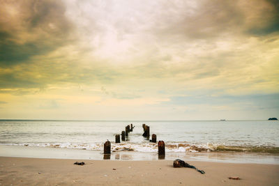 People on beach against sky