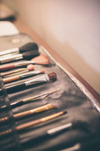Close-up of make-up brush set on table
