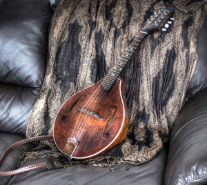 High angle view of guitar on sofa